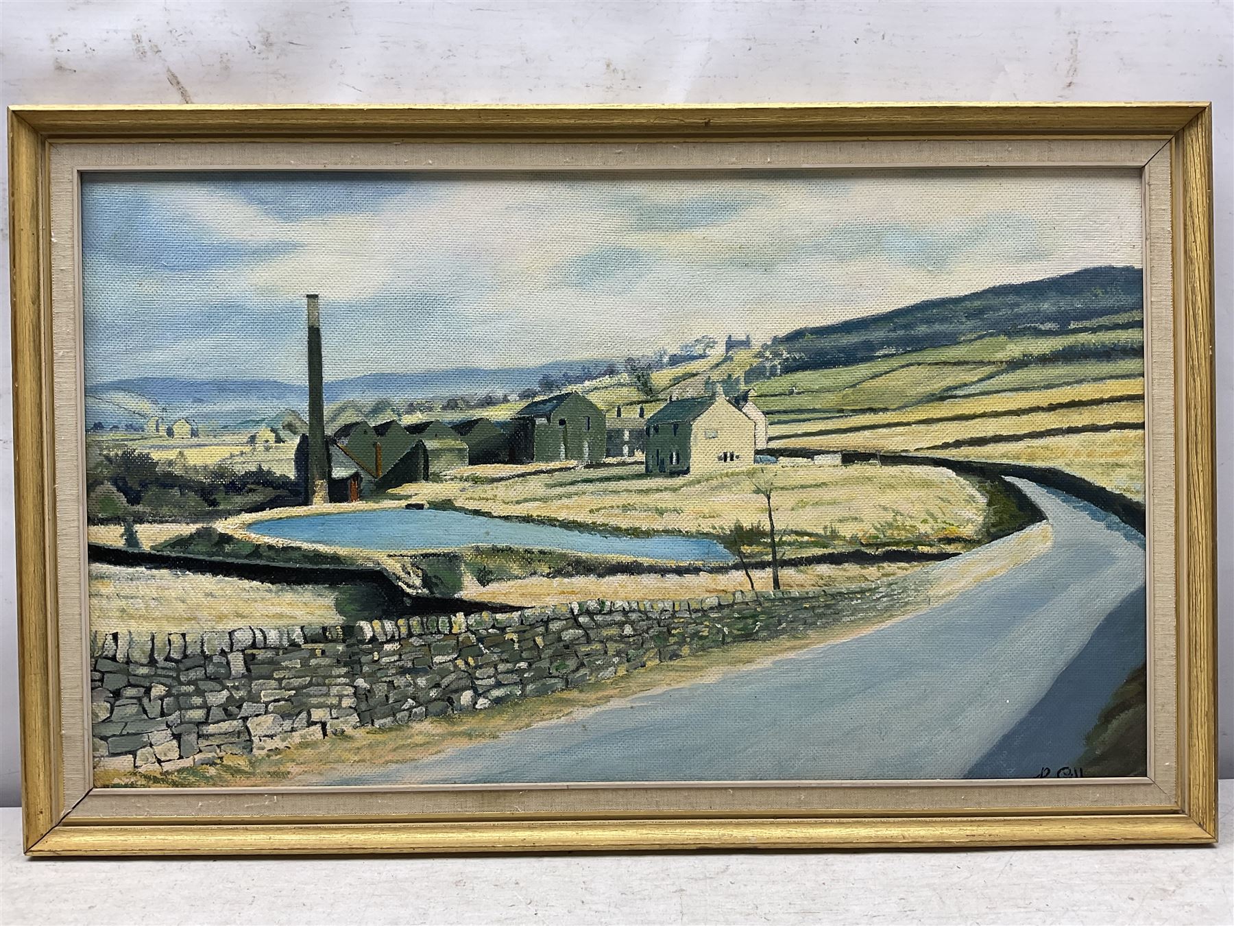 Keith Sutton (British 1924-1991): A Sussex Street, oil on canvas signed 44cm x 56cm; R Gill (Northern British 20th Century): Yorkshire Village on a Hill, oil on board signed 40cm x 70cm (2)