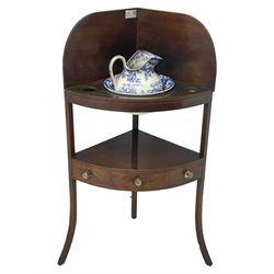George III mahogany corner washstand, raised shaped back over two tiers, the lower tier fitted with single drawer, on square supports with out-splayed feet, together with wash jug and bowl 