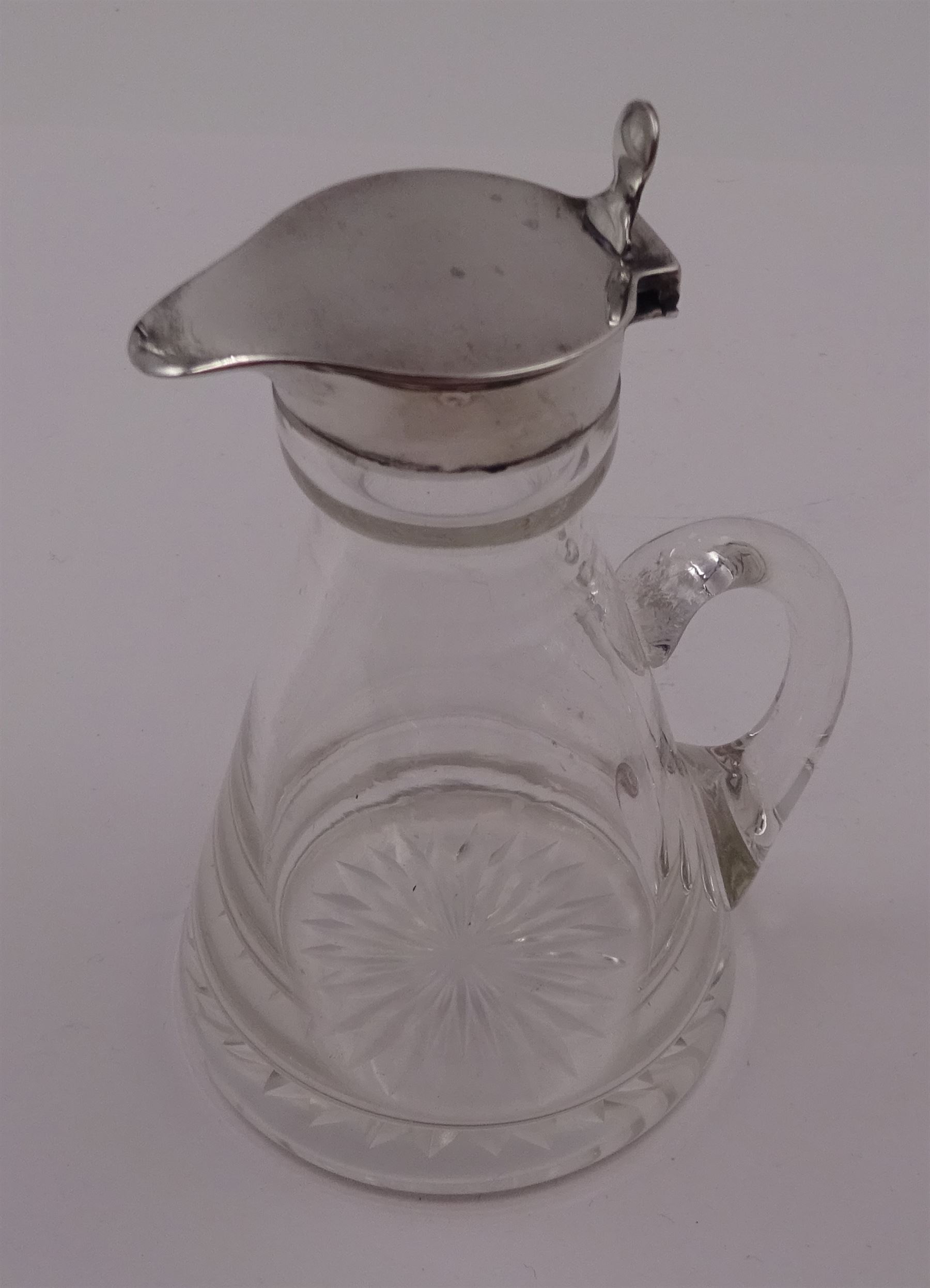 1930s silver mounted glass whiskey tot, with C handle and star cut base, the silver collar and cover with thumbpiece, hallmarked S Blanckensee & Son Ltd, Birmingham 1932, including thumbpiece H10.5cm