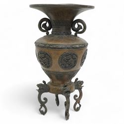 Late 19th/ early 20th century Japanese bronze Usubata vase, the flared top over two Phoenix cast handles, the ovoid body decorated in relief with mythical creatures within roundels, on four open mouth lion mask and scroll supports, H43cm x W24cm 