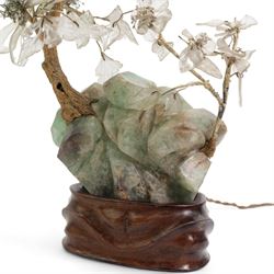 Early 20th century Chinese carved fluorite and crystal table lamp, depicting a blossoming tree on a rocky outcrop, on a carved hardwood stand inset with a bulb, H40cm