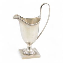 Edwardian silver helmet shaped cream jug, with C scroll handle and upon square base, hallm...