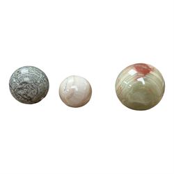 Collection of three stone spheres including onyx example