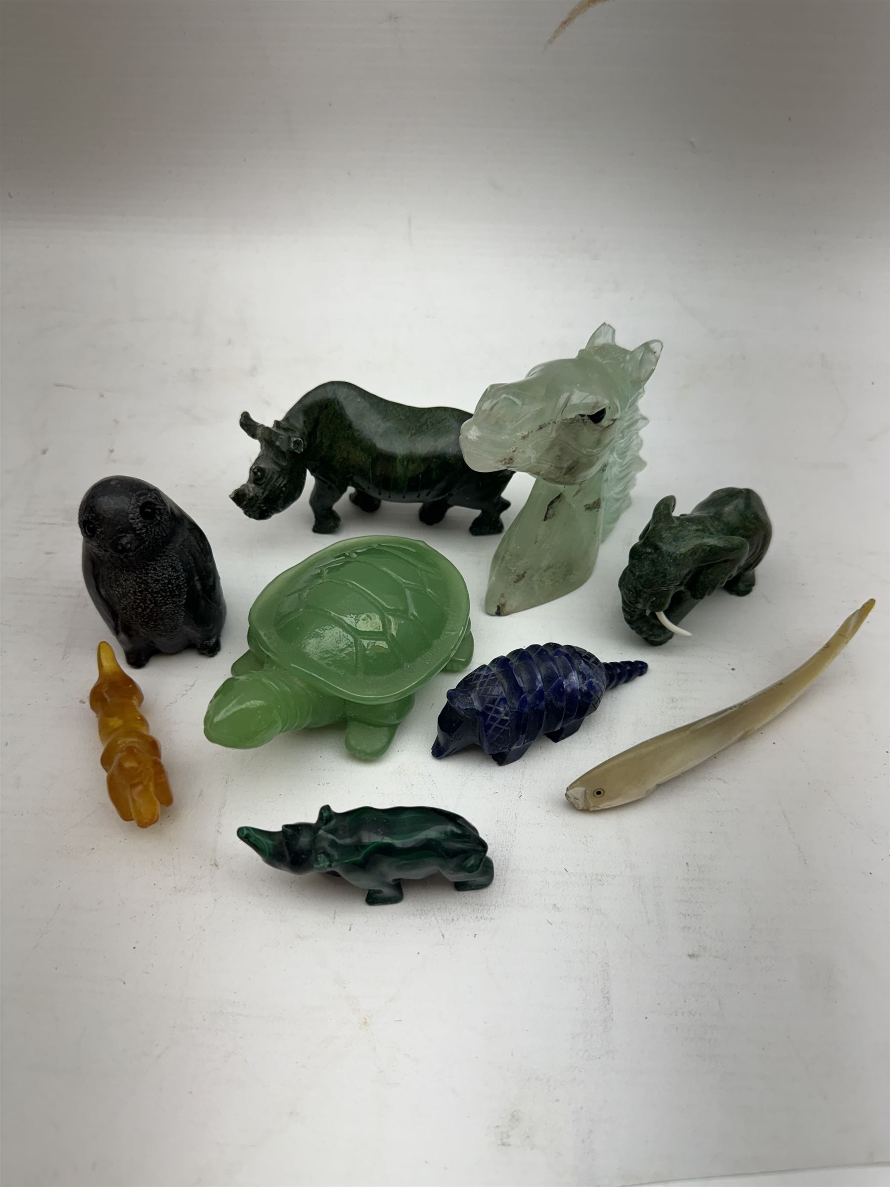 Collection of carved stone animals including  Lapis Lazuli armadillo, Malecite rhino, Amber dog etc  