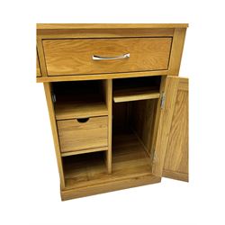 Contemporary light oak twin pedestal desk, fitted with three drawers over two cupboards with chrome handles, the central drawer with hinged front panel revealing pull-out keyboard tray, on plinth base