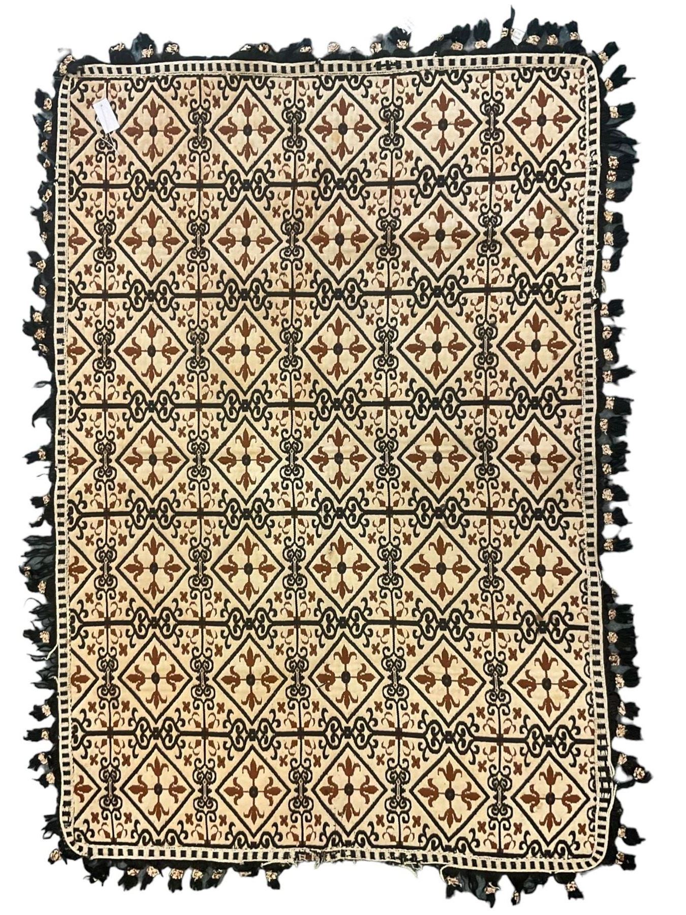 Flatweave pale ground rug, multiple panels decorated with lozenges, divided by scrolled decoration 