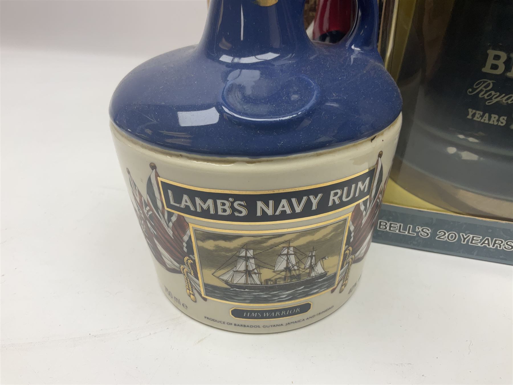 Bells, Scotch whisky, in five Wade ceramic decanters, together with Irish Mist  in novelty decanter, an empty Lambs Navy Rum decanter and similar items, of various content and proof, (11)