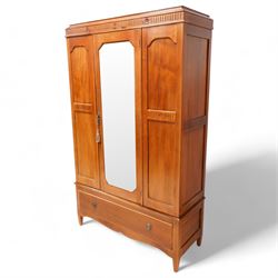 Early 20th century mahogany three piece bedroom suite - comprising a triple wardrobe (W119cm D47cm H194cm); chest with raised back, fitted with four long drawers (W93cm D49cm H115cm); and dressing table with swing mirror back (W108cm D49cm H152cm), each decorated with rosette and fluted designs, on square tapering feet