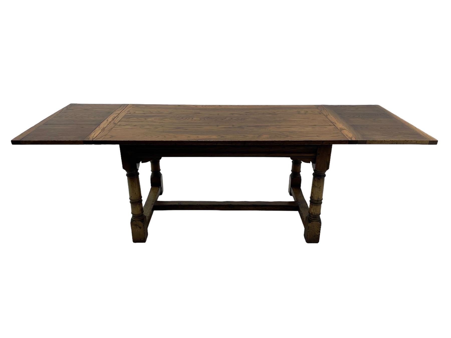 Oak refectory dining table, rectangular three plank top with cleated ends, two additional leaves, on turned supports united by H-stretchers 