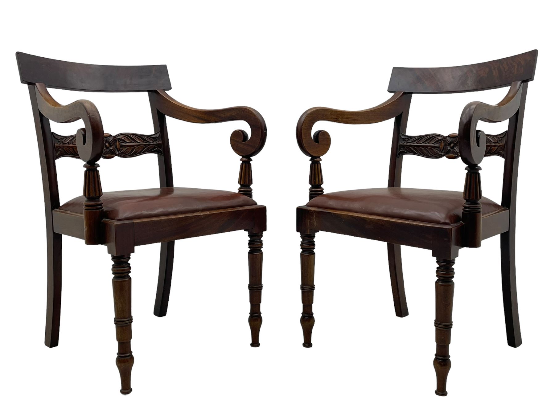 Set of six (4+2) early 19th century mahogany dining chairs, figured bar back over rose and curled leaf carved middle rail, drop-in seats upholstered in brown fabric, on turned front supports 