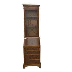 Mid-to-late 20th century yew wood bureau bookcase, raised bookcase enclosed by glazed door, the fall front revealing fitted interior, four graduating cock-beaded drawers below, on bracket feet