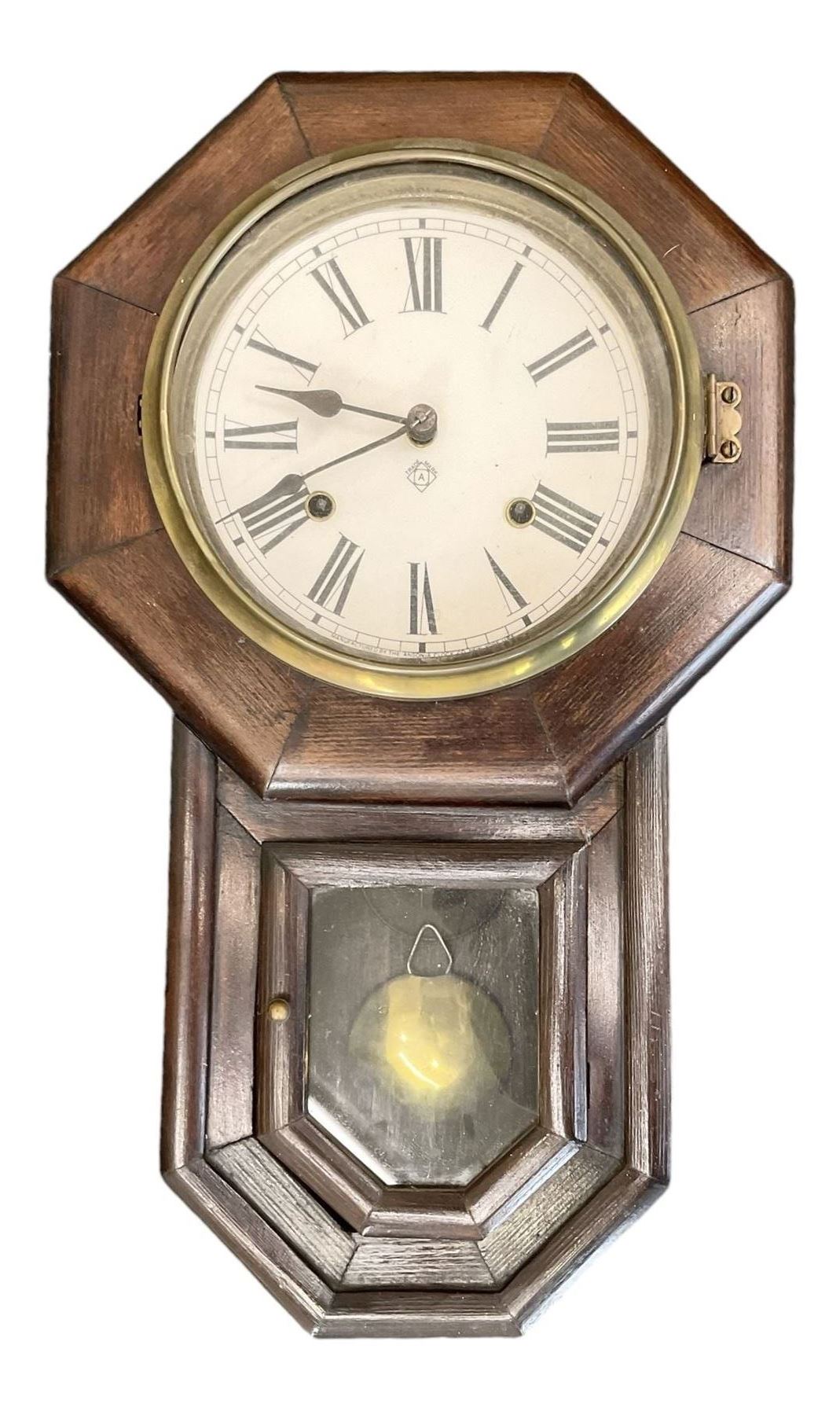 Ansonia- American 8-day oak cased drop dial wall clock with a octagonal dial frame and visible pendulum, striking the hours on a gong.