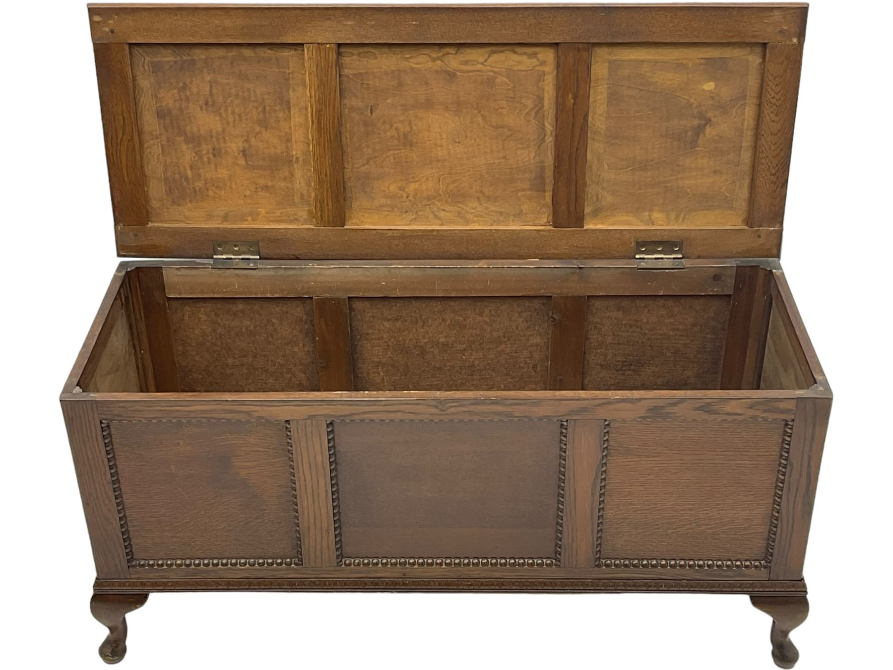 Early 20th century oak blanket chest, rectangular hinged lid with decorative panelling, the front and sides adorned with beaded panels, on cabriole feet