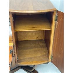 Beautility - mid-20th century walnut sideboard, fall-front with sliding top enclosing mirror interior, fitted with two drawers and flanking cupboards, on sledge feet with curved stretchers 