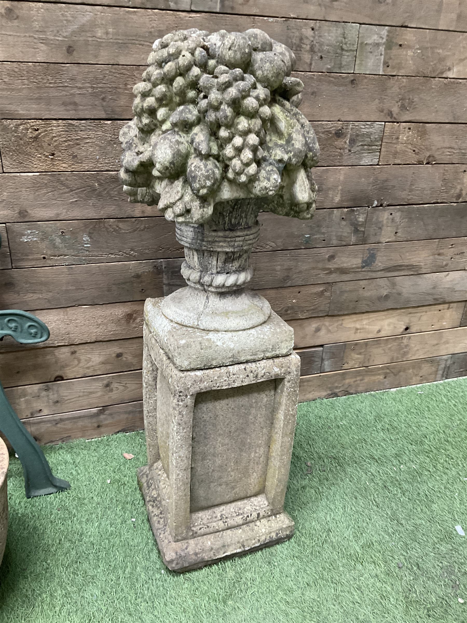 Cast stone garden fruit centrepiece on square base, pair of cast iron bench ends, and three planters - THIS LOT IS TO BE COLLECTED BY APPOINTMENT FROM DUGGLEBY STORAGE, GREAT HILL, EASTFIELD, SCARBOROUGH, YO11 3TX