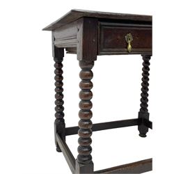 18th century oak side table, ovolo-moulded rectangular two plank top over single drawer with applied mouldings, on bobbin turned supports joined by stretchers, pegged construction, pressed putti mask handle plates and drop handles 