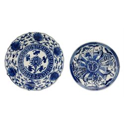 19th century Chinese blue and white saucer dish decorated in the Long Eliza pattern, four character mark within double circle beneath, D13.5cm, and a Chinese shaped dish painted with lotus flowers, provincial shop mark within square border beneath (2)