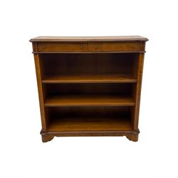 Figured walnut open bookcase, moulded top over two drawers and two shelves, on plinth base 