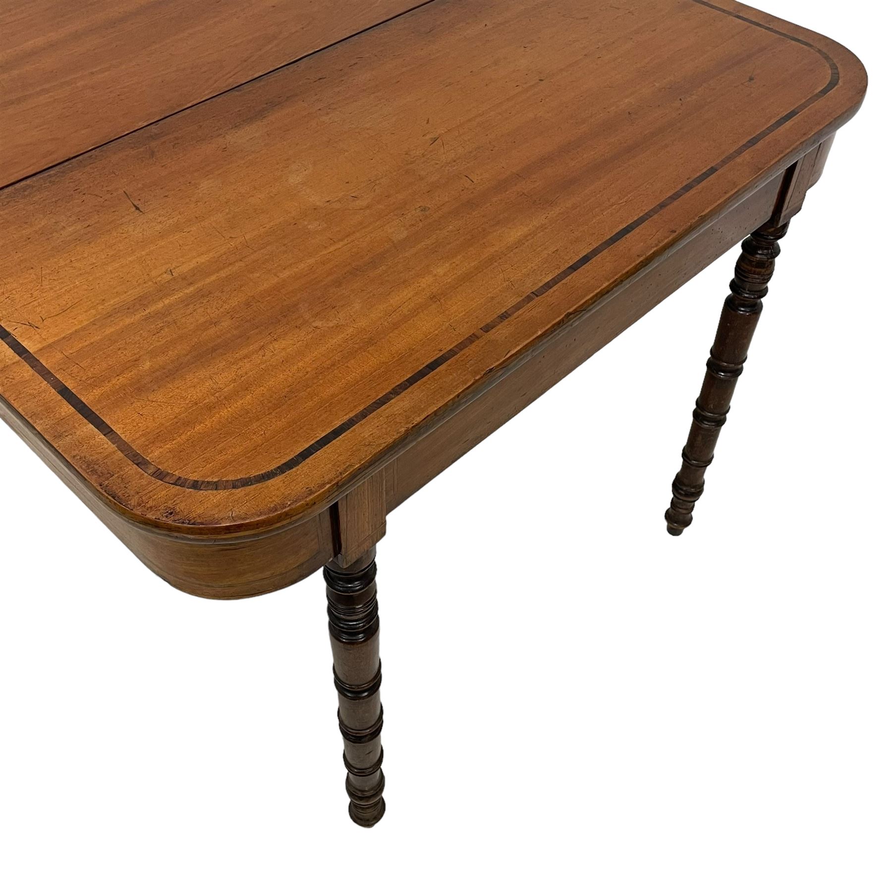 Early 19th century mahogany tea table, rectangular fold-over top with rounded corners, inlaid with mahogany banding, the plain frieze with mahogany stringing, raised on gate-leg action ring turned supports