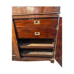 Victorian mahogany linen press, projecting cornice with dentil and scroll detailing, double panelled doors opening to an interior fitted with a brass hanging rail and coat hooks, lower section with two drawers and fitted shelves for additional storage, raised on bracket feet