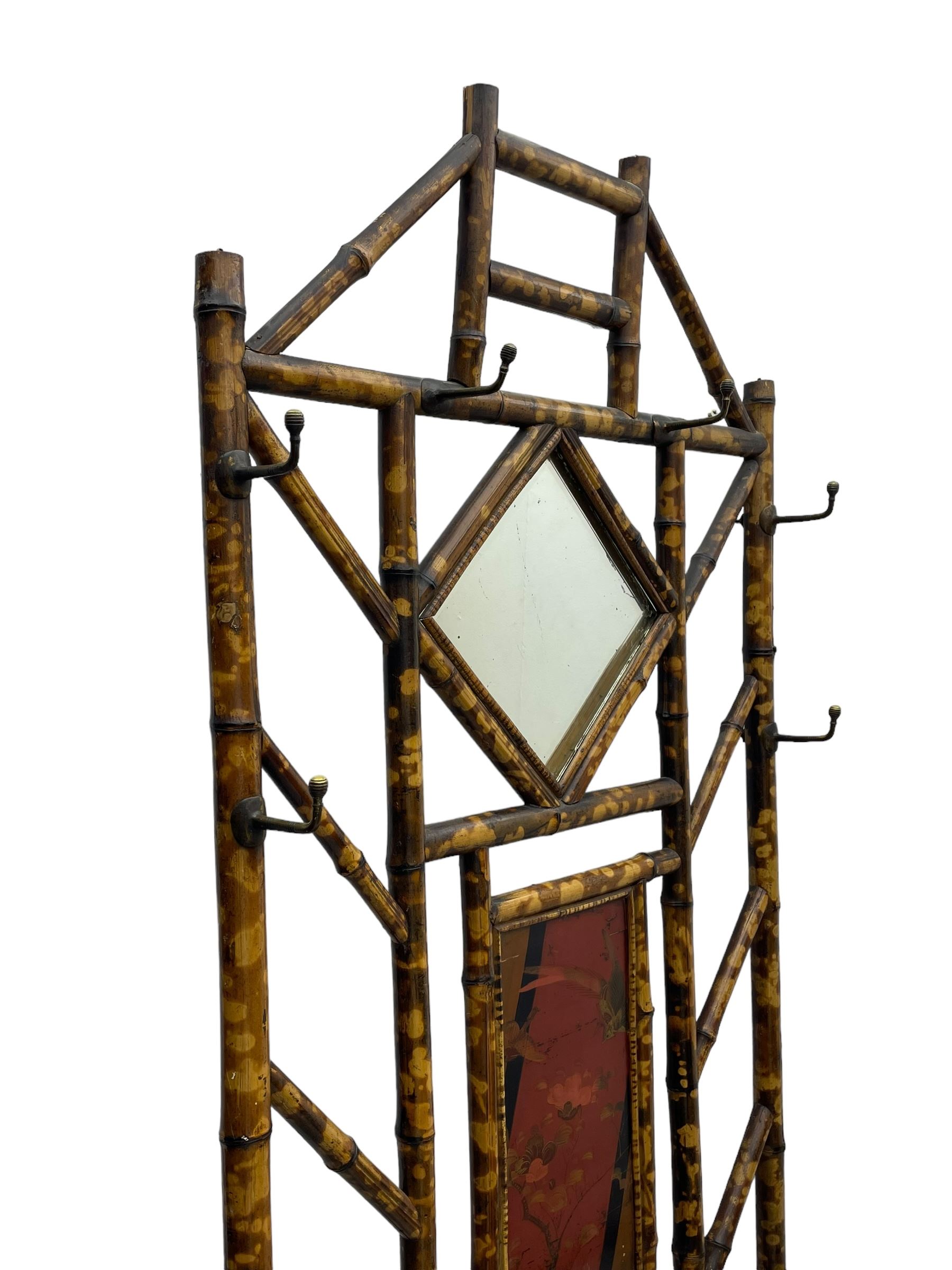 Victorian bamboo hallstand, bevelled mirror over red lacquered and chinoiserie decorated panels, fitted with six brass hooks 