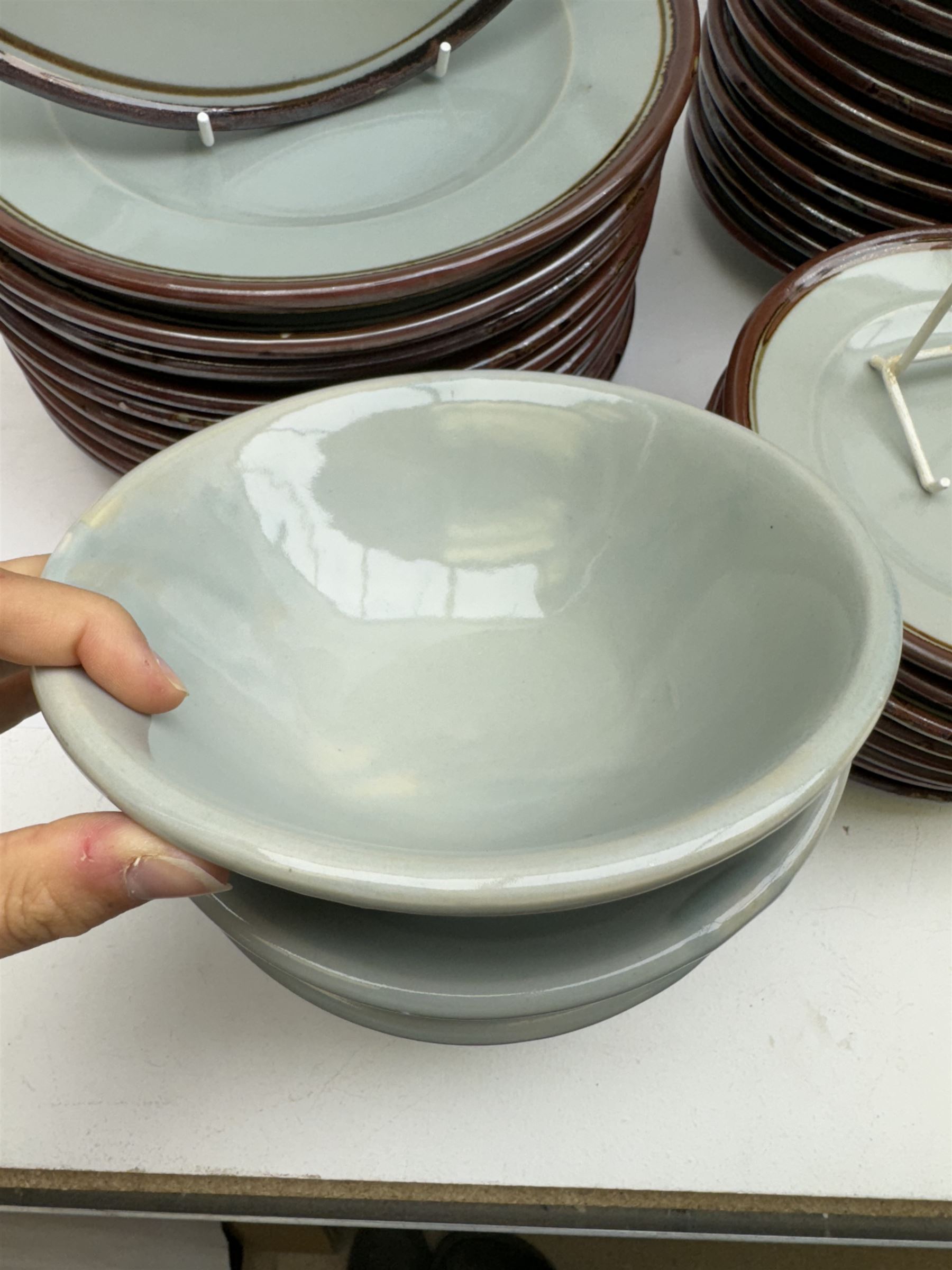 20th century celadon dinner service with iron rim, comprising nineteen dinner plates 26.5cm, twenty-four side plates D24cm, twelve varying bowls, twenty-two tea plates and fifteen saucers 