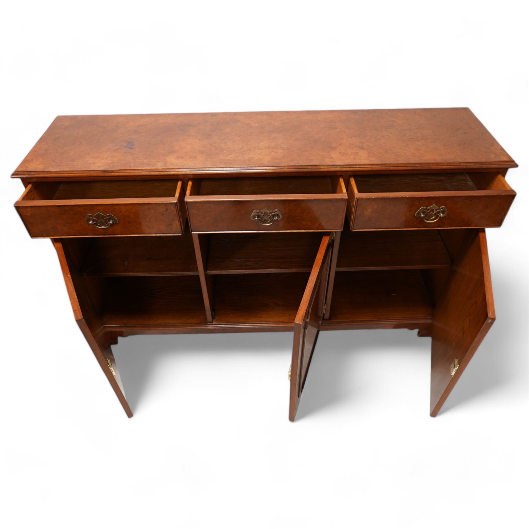 Georgian design figured walnut sideboard, moulded rectangular top over three drawers and three cupboards, on bracket feet 