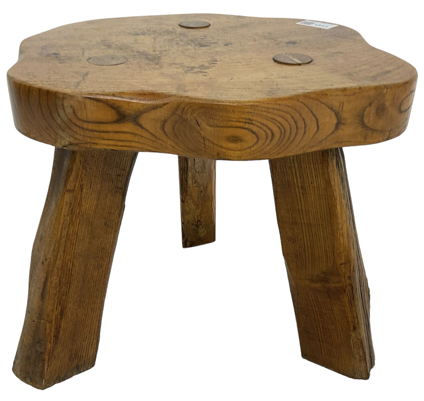 Small rustic elm three-legged stool, with metal plaque to the underneath inscribed 'Wandewood' 