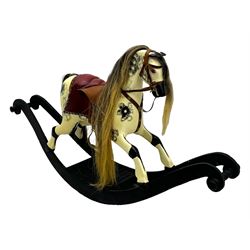 Mid-to-late 20th century carved wooden rocking horse, in dapple grey finish with leather saddle and bridle, mounted on a black painted rocking frame with shaped ends