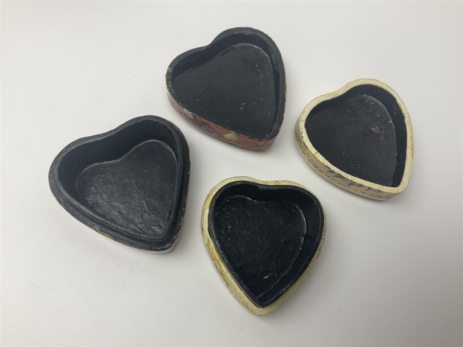 Nine lacquered boxes, including seven heart shaped examples, mainly decorated with floral designs, largest H12cm