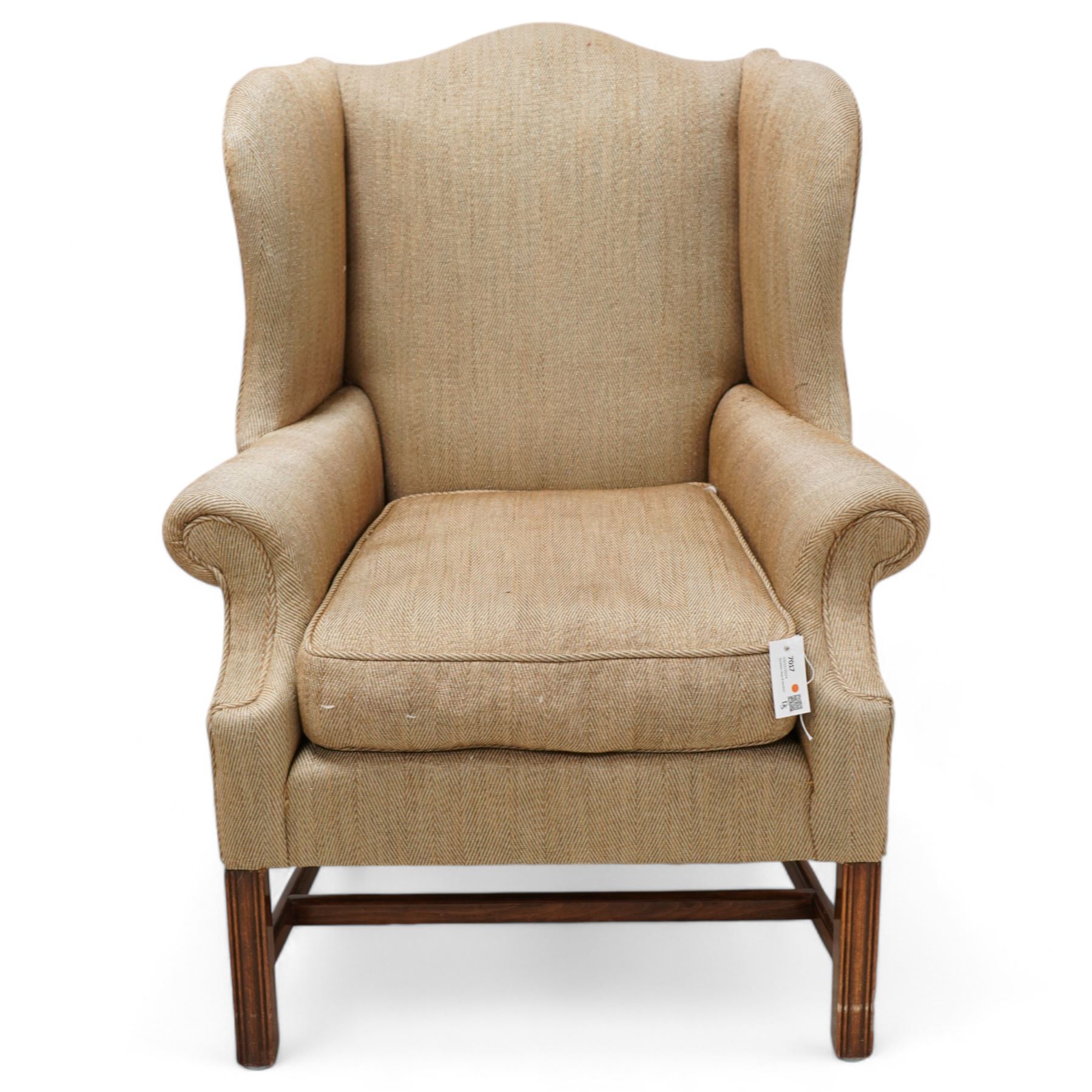 Georgian design wingback armchair, upholstered in brown herringbone fabric, on square moulded supports united by plain H-stretchers