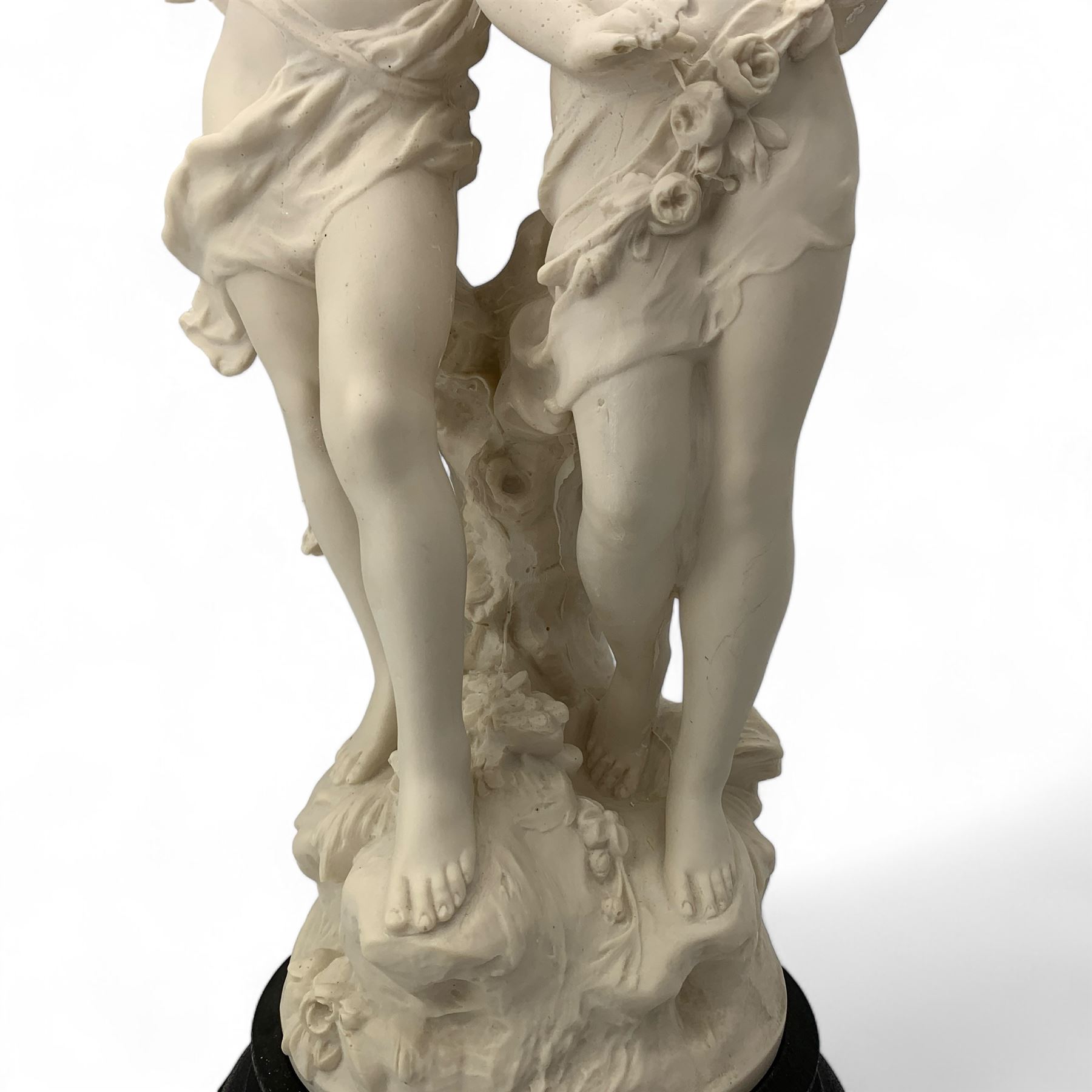 After Auguste Moreau, 20th century faux alabaster figural group 'La Fete Des Fleurs', on circular ebonised plinth, H57cm