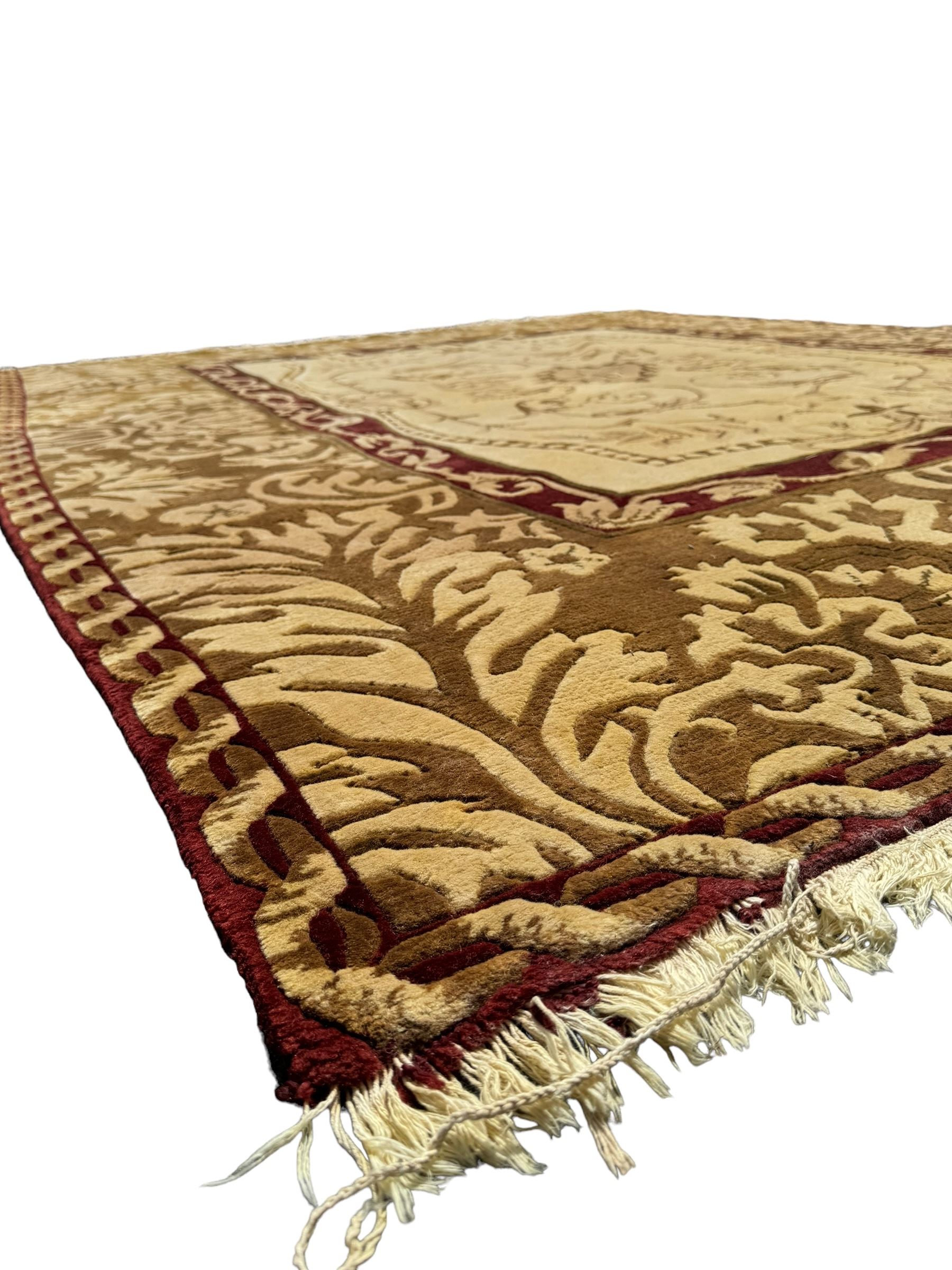 Persian Tabriz design beige ground rug, the field decorated with a central medallion featuring scroll and leaf motifs, surrounded by a burgundy frame with floral patterns, the main border showcasing a series of stylised floral and leaf designs in beige and brown tones, enclosed by an outer band with interlocking chain motifs