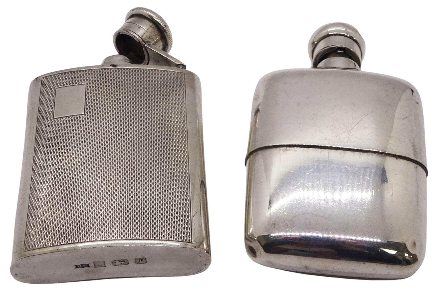 Modern silver hipflask, with engine turned panel to front and vacant rectangular panel to upper left corner, hallmarked William Manton, Birmingham 1989, H9.5cm, together with another modern silver hipflask hallmarked London import, 1990, makers mark indistinct, H10cm, approximate total weight 6.97 ozt (217 grams)