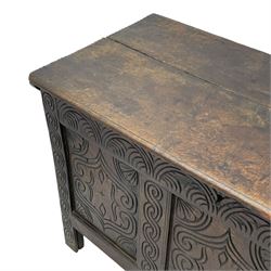 18th century oak blanket box, moulded and chip carved hinged lid, lunette carved cresting rail over triple panelled front carved with stylised leaf and scroll decoration, interlocking S-scroll carved upright rails, panelled sides and back, on stile supports 