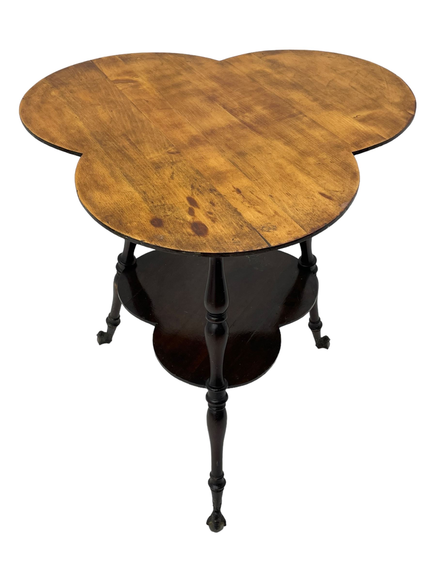 Late 19th to early 20th century stained beech 'Gypsy' table, trefoil or clover shaped top on turned supports united by undertier, on cast metal and glass ball feet 