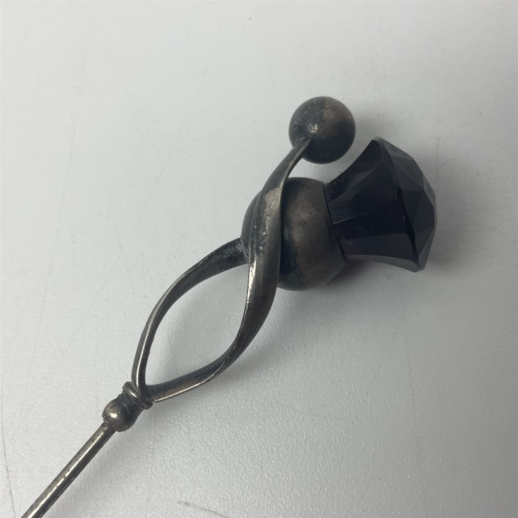 Silver hatpin modelled as a thistle, by Charles Horner, together with three other silver hatpins, modelled as a tennis racket, golf club and Medusa mask, all hallmarked 