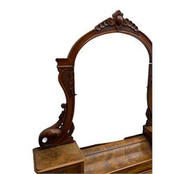 19th century figured walnut dressing table, the raised bevelled mirror back in carved foliage frame with scrolled terminals, fitted with central hinged compartment flanked by small trinket drawers, serpentine moulded top over single frieze drawer, on cabriole supports united by a platform base