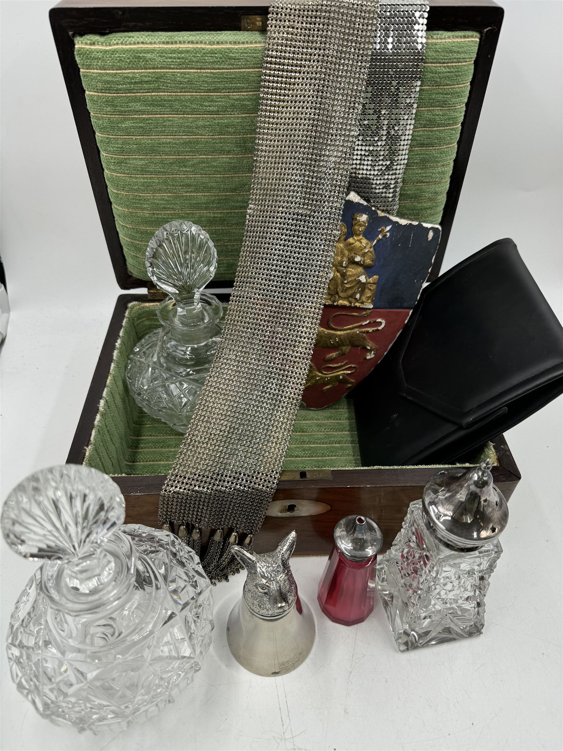 Two cut glass decanters, together with a faceted red glass bottle, cut glass sugar caster with pierced star cover, silver plated stirrup cup, chainmail scarf, plaster ships plaque and a walnut box with mother of pearl cartouche