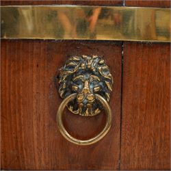 George III Chippendale design brass bound mahogany wine cooler of oval form, the coopered body enclosed by two brass brands, with lead liner to interior, fitted with twin lion mask ring handles, raised on square tapering supports