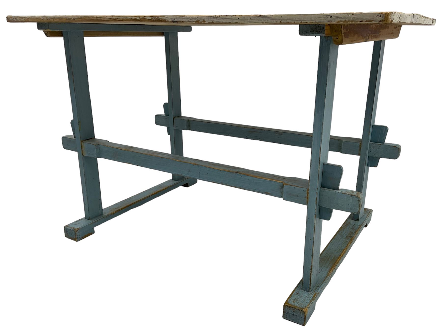 Early 20th century pine rustic dining table, rectangular plank top with weathered patina, over trestle-style supports in distressed blue paint with central stretcher