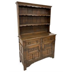 Georgian design oak dresser, two-tier plate rack with shaped aprons, the base fitted with two fielded moulded drawers, over two panelled cupboards carved with scrolling acanthus leaves, with guilloche carved central upright, on stile feet