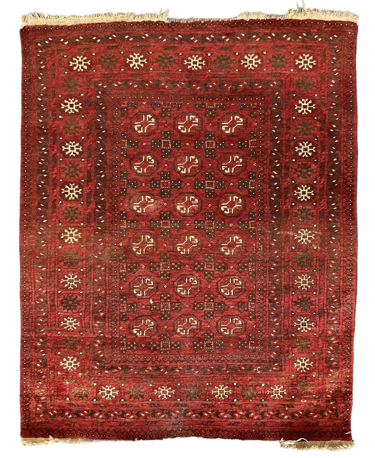 Antique Persian crimson ground rug, the field decorated with Gul motifs, the guarder border with stylised stars in ivory and dark indigo