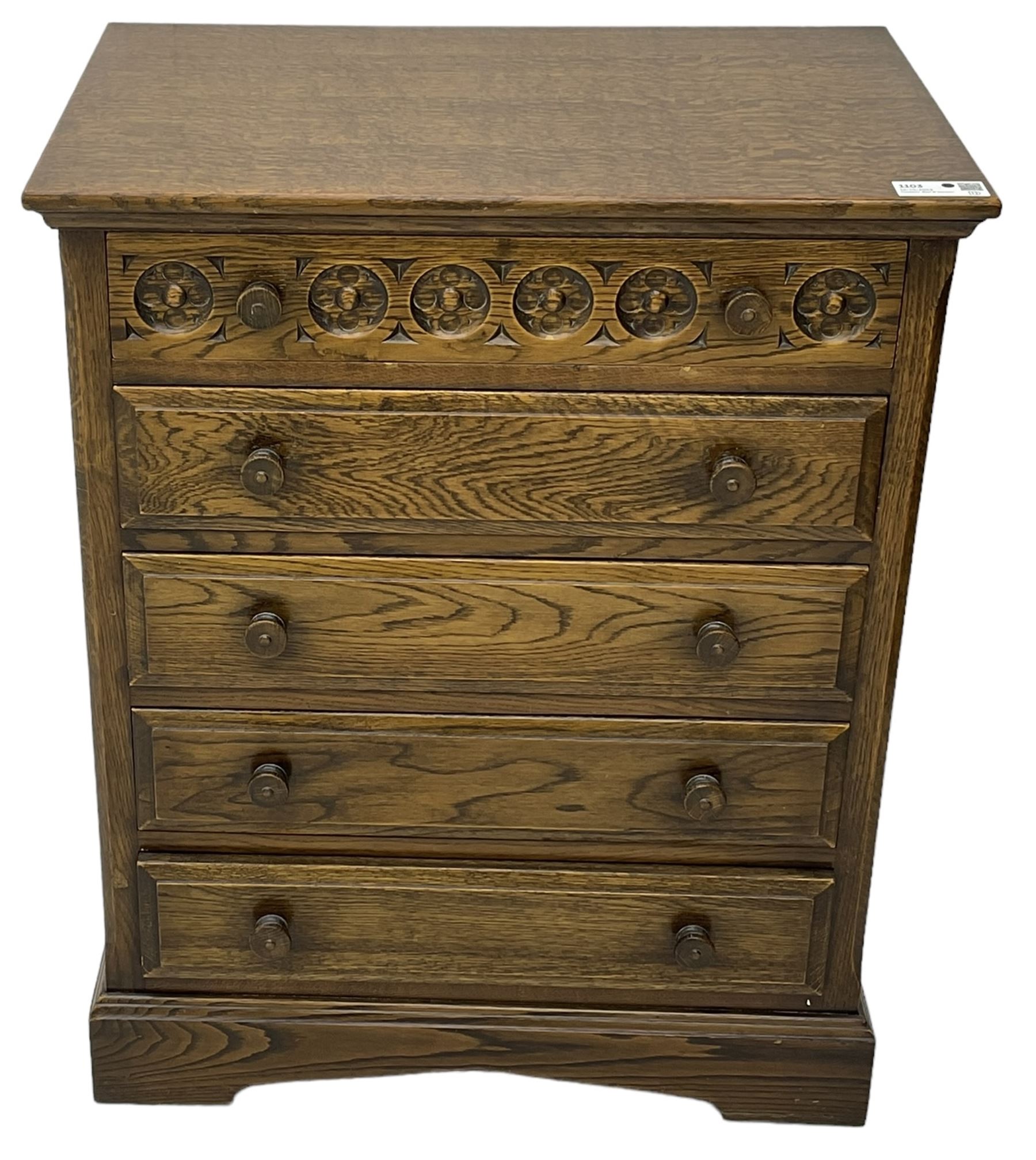 Mid-20th century oak chest, fitted with five drawers, the top drawer carved with flower head roundels, on bracketed plinth base 