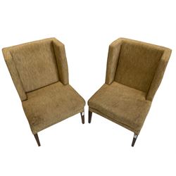 Two wing back armchairs, upholstered in oatmeal fabric