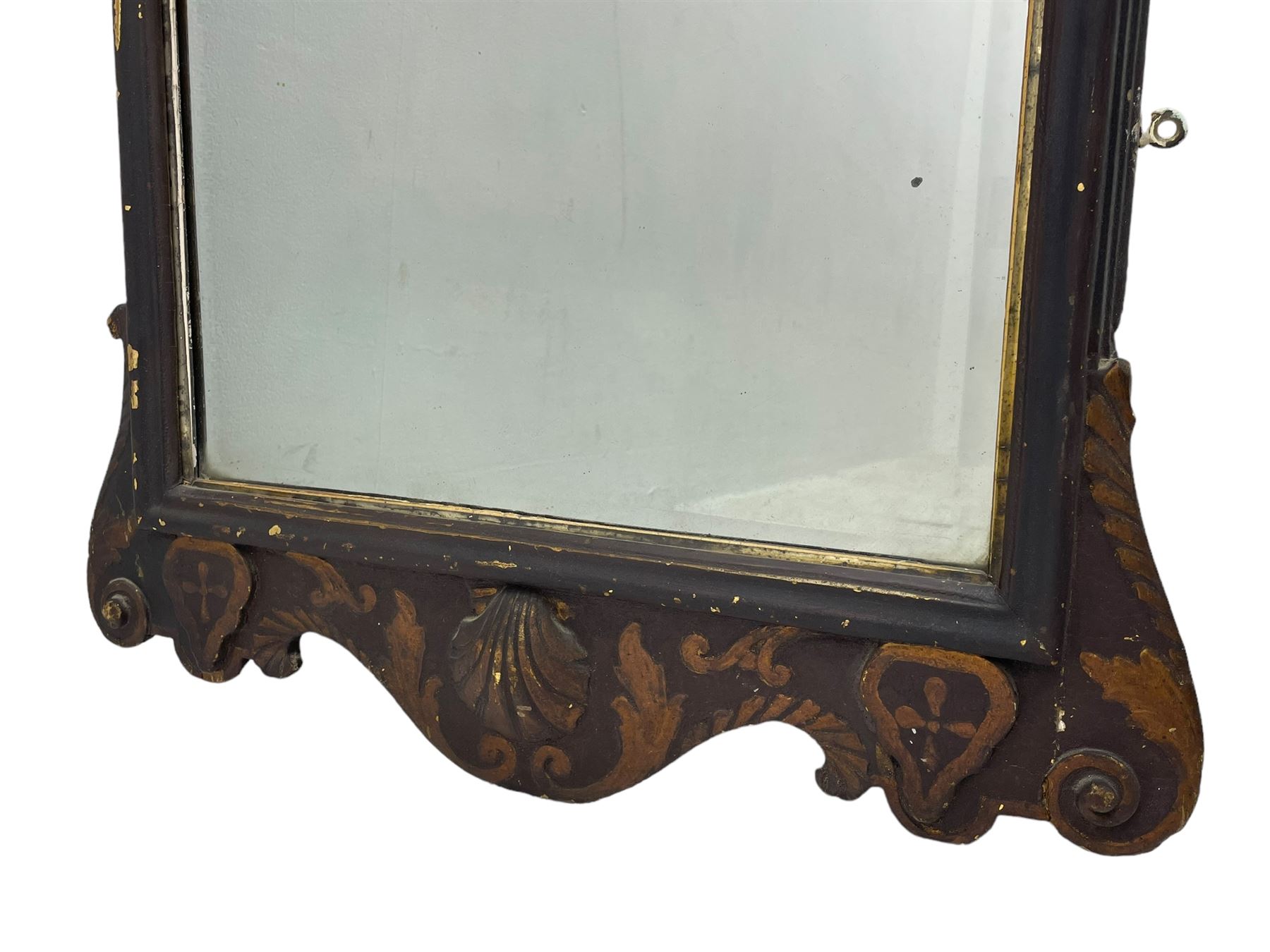 18th century black lacquered and gilt wall mirror, broken arch pediment with central cartouche decorated with curled leaves and foliate motifs, scrolled acanthus leaf eared brackets, bevelled mirror plate within gilt slip and moulded outer frame, lower shell motif surrounded by curled acanthus leaves and shield motifs 