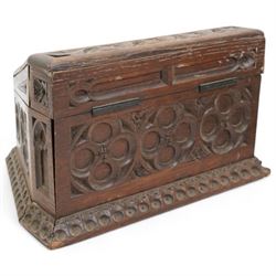 Late Victorian oak stationery box carved with Gothic and foliate panels, hinged sloping lid and divided interior with the trade label of H Ladd, 34 Trinity St. Cambridge, Stationer & Die Sinker W26cm