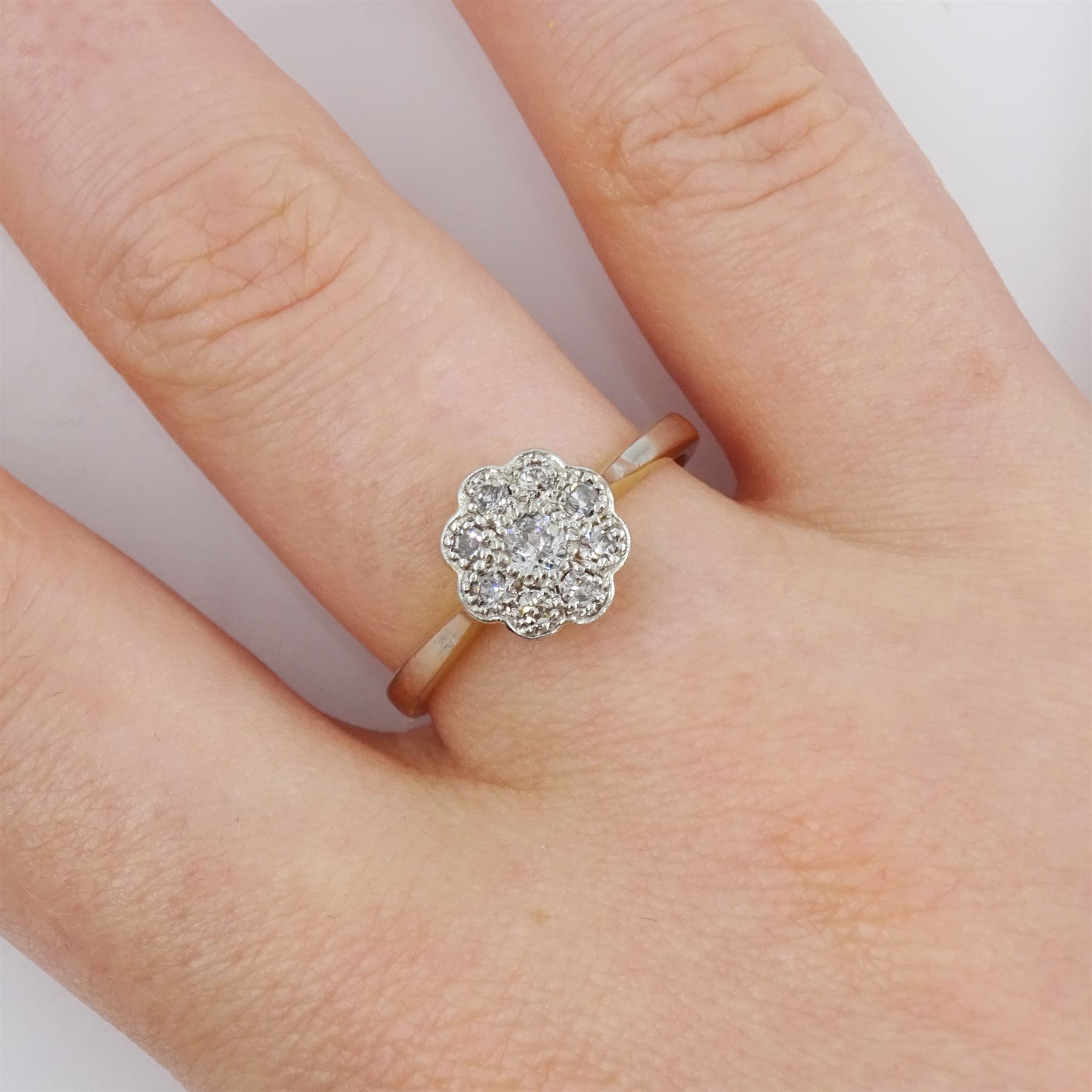 Early - mid 20th century milgrain set transitional cut diamond daisy cluster ring, stamped 18ct Fine Plat, total diamond weight approx 0.25 carat