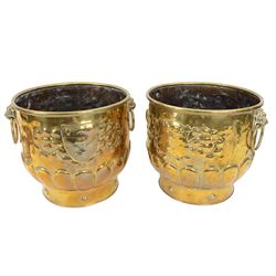 Pair of large brass planters, each with twin lion mask ring handles, and repousse decorati...