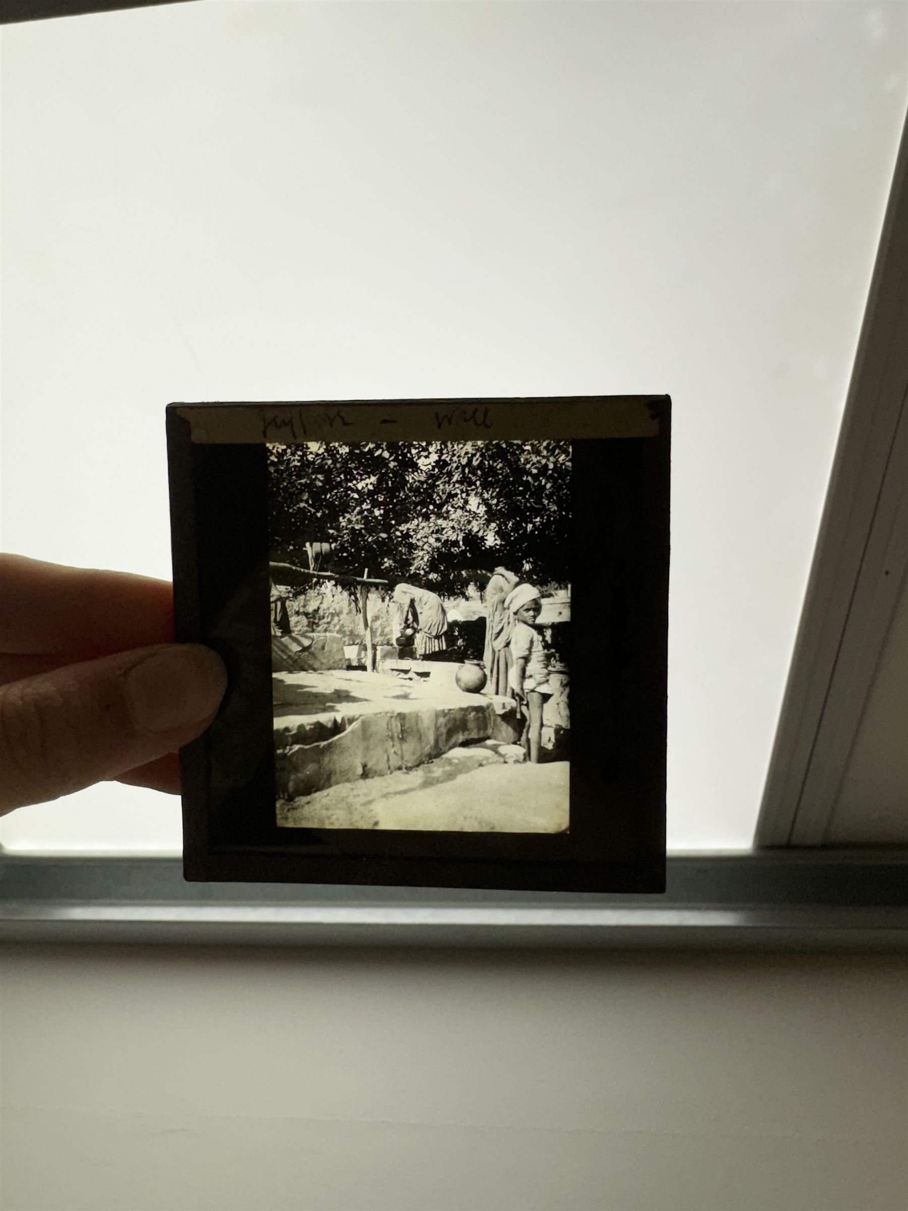 Collection of magic lantern slides, predominantly depicting views of India, with scenes including including the Taj Mahal, tombs, monuments, street scenes, people and animals, in compartmentalised wooden case 